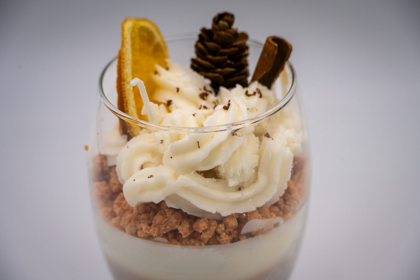 This beautifully crafted Macchiato&nbsp;parfait dessert is featured by&nbsp;foamed milk on espresso, layering on top with crumbled biscuit and whipped cream, garnished with a dried orange slice, a small pine cone, and a cinnamon stick, suggesting autumnal or winter seasonal flavors. Enjoy this lovely&nbsp;treat!
