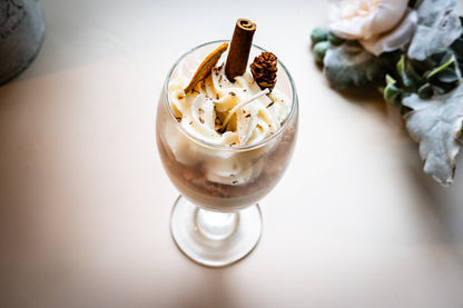 This beautifully crafted Macchiato&nbsp;parfait dessert is featured by&nbsp;foamed milk on espresso, layering on top with crumbled biscuit and whipped cream, garnished with a dried orange slice, a small pine cone, and a cinnamon stick, suggesting autumnal or winter seasonal flavors. Enjoy this lovely&nbsp;treat!
