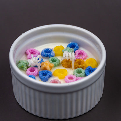 This handcrafted cereal candle is a whimsical home decor piece that perfectly mimics a bowl of colorful fruit loops cereal floating in white milk, providing a delightful, nostalgic aroma of the classic breakfast treat. It's a fun, foodie item designed to evoke happy childhood memories. 
