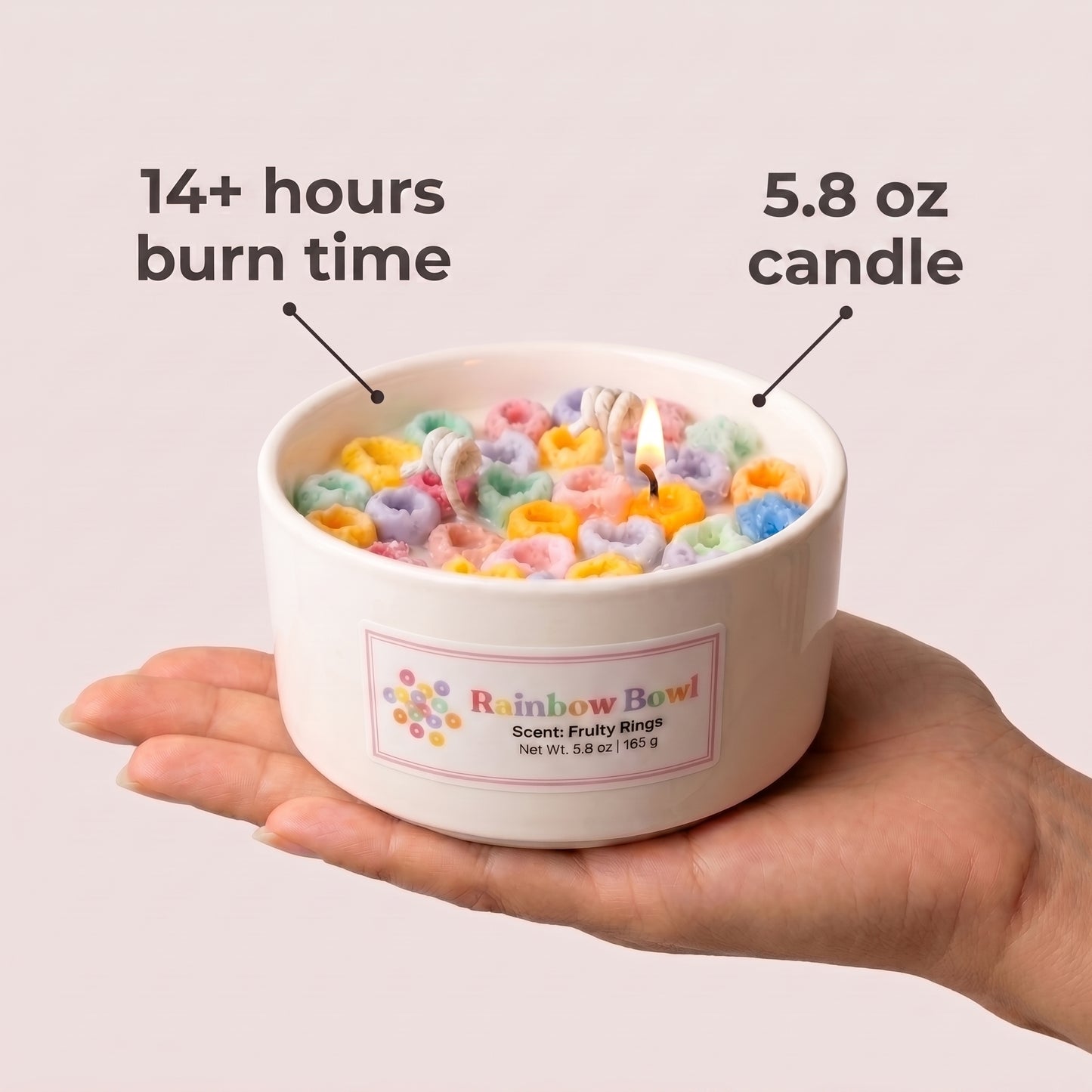 Candle in a bowl with colorful rings held by a hand, labeled with burn time and weight.