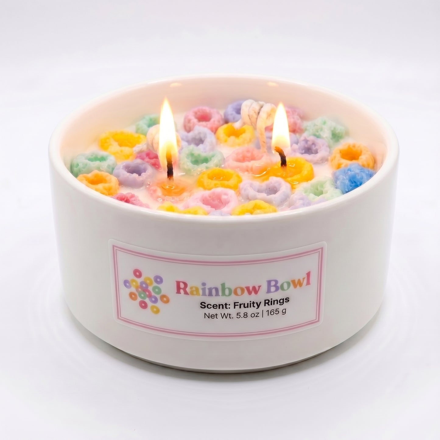 Candle in a bowl with colorful floral design and 'Rainbow Bowl' label on a white background