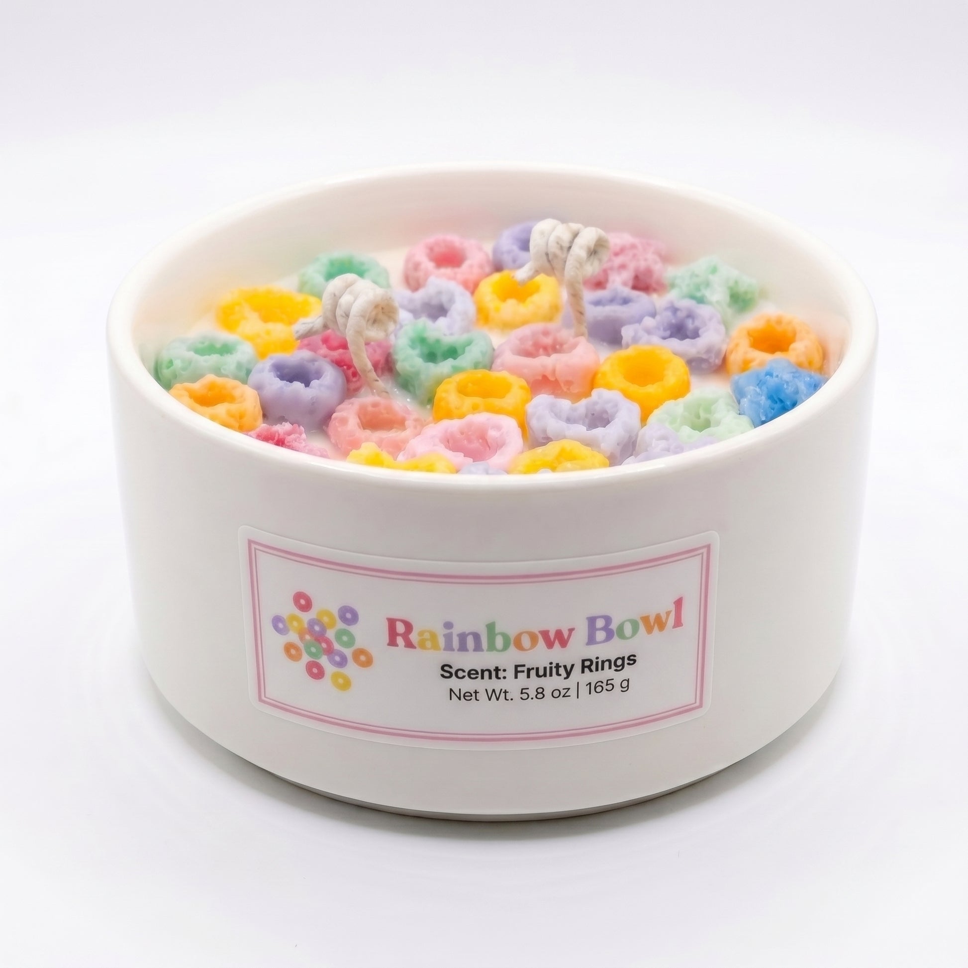 White container filled with colorful cereal-like treats labeled 'Rainbow Bowl' on a white background